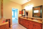 Master bath with wood cabinets and granite tops