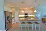 Kitchen with gathering island and designer pendant lights