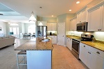 Kitchen features a corner pantry and recessed lighting