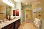 Master bath features a double vanity with granite tops and wood cabinetry