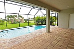 Pool with brick paver deck and water feature