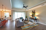 Great room showcasing tray ceiling with crown molding